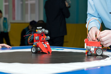a student sets up a red robot