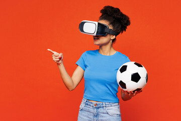 Young woman fan wear blue t-shirt cheer up support football sport team hold soccer ball watch tv...