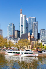 Frankfurt skyline skyscrapers with banks on River Main with excursion boat portrait format in Frankfurt, Germany