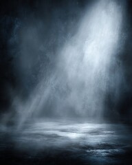 A dramatic spotlight shines through mist onto a dark, empty stage, creating an atmospheric and mysterious ambiance