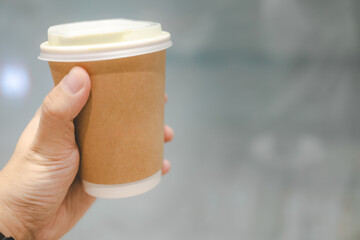 Hand Holding Sustainable Paper Coffee Cup. a recyclable or biodegradable paper coffee cup. Eco friendly products. reducing waste, and conscious consumption.