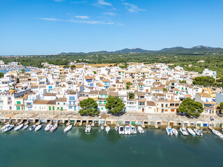 Portocolom fishing village on Mallorca island aerial view from above with boats holiday by the sea in Spain