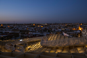 A view across the city of Seville, Andalusia, Spain, at night, from the walkway of the famous landmark, Metropol Parasol, also know as Las Setas de Sevilla, or the mushroom.