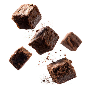 Pieces of chocolate brownies floating or falling in mid air isolated on white background simple stock clear photo colorful white picture concept realistic concept portrait clean clean concept high rea