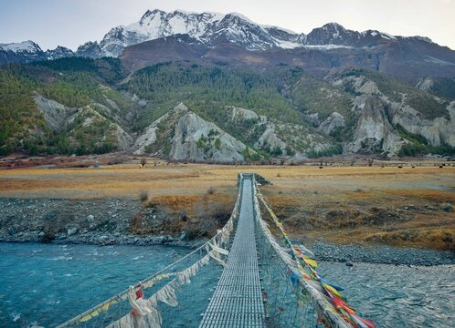 Himalayas, Nepal - The famous hiking on the roof of the world called Annapurna Circuit in Himalaya range mountain, with little village, buddhist stupa and mountains of 8000 meters.