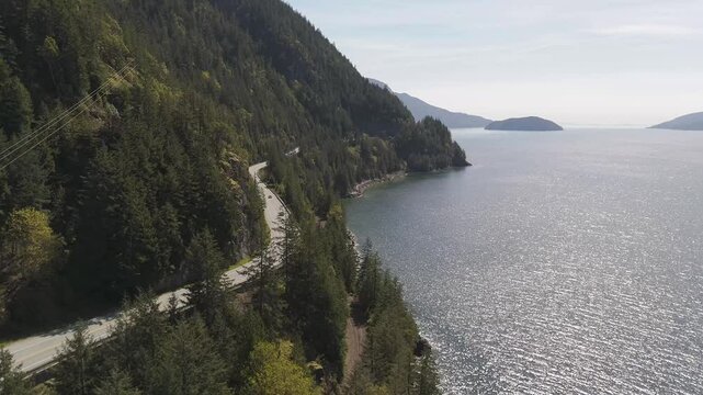 Cars Drive on Sea to Sky Highway Along Howe Sound in British Columbia