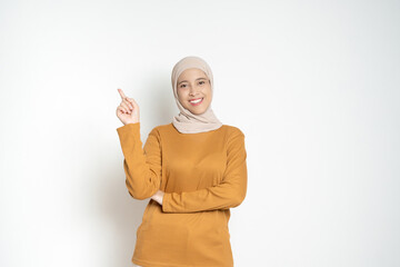 Confident Woman Pointing Upwards in Casual Attire isolated on a White Background