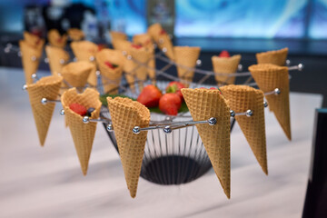 Elegant and Beautiful Dessert Presentation Featuring Ice Cream Cones Alongside Fresh Strawberries