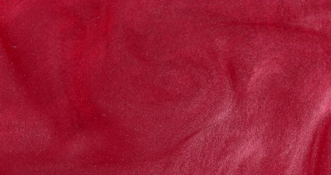 Abstract waves texture. Glitter in red liquid abstract background. Metallic red texture, swirls.