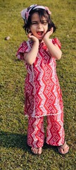 little girl in a red dress In Kashmir 