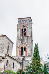 The iconic bell tower of Ravello, Italy, showcasing its medieval architectural charm. Surrounded by lush greenery and situated in the heart of the town, this landmark represents the rich cultural and 