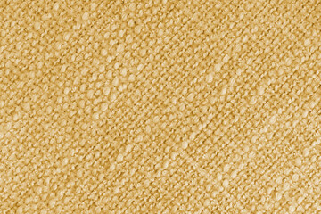 Close up, macro of yellow woven fabric with detailed texture and diagonal pattern. Textile, cloth, material, fashion, upholstery, or abstract design background.