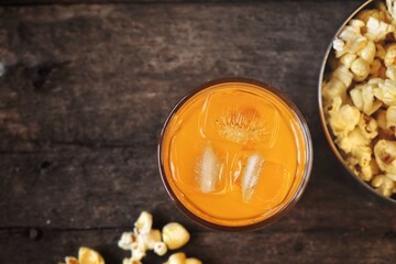 Pop corn and orange soft drink