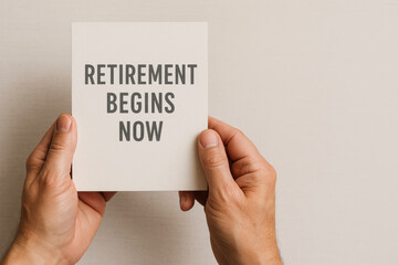 Retirement begins now message on card held by hands symbolizing start of new chapter and celebration for retirement party filled with joy and anticipation