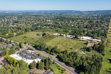 Aerial drone picture of a beautiful residential area in Cedar Mill, Portland, OR, captured at morning. Picture shows lush green courtyards, parking lots and housing buildings	
