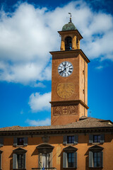 Clock tower with sundial and baroque details in Reggio Emilia historic center, Italy 