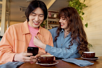 Multicultural friends enjoying a joyful moment together in a cozy cafe setting