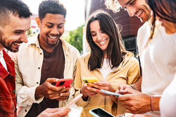 Happy young people having fun watching smart mobile phone device - Technology life style concept