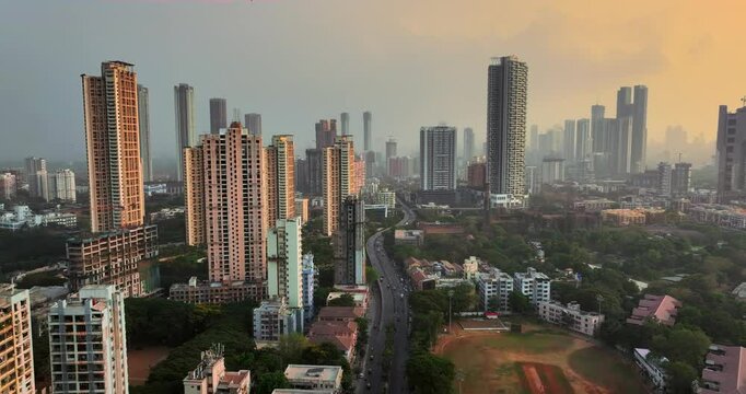 Golden Horizons: Captivating Evening Aerial of Mumbai's Skyline at Sunset, Over Lower Parel, Mahalaxmi, and Currey Road. High-rise buildings. High-rise residential buildings in an Indian city.