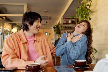 Young friends share laughter and connection in a cozy cafe setting full of joy