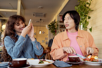 Friends enjoying a delightful moment at a cozy cafe with brunch and conversation