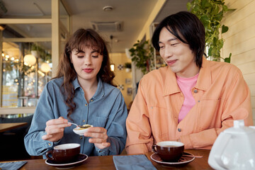 Friends enjoying tea and conversation in a cozy multicultural cafe