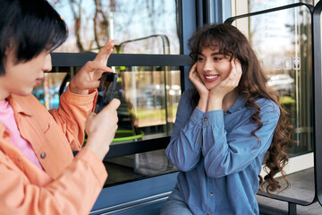 Multicultural friends capturing joyful moments together in a cozy cafe
