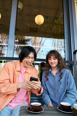 Multicultural friends enjoy cafe moments, sharing laughter over coffee and smiles
