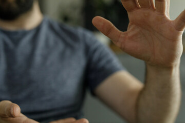 Close-up of a man's hands reaching out, wearing a simple t-shirt.  Perfect for concepts of...