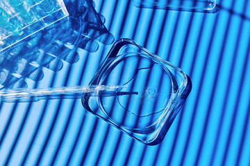 Sample being pipetted into petri dish and test tube for analysis in laboratory. Science research, medical trial  and development concept.
