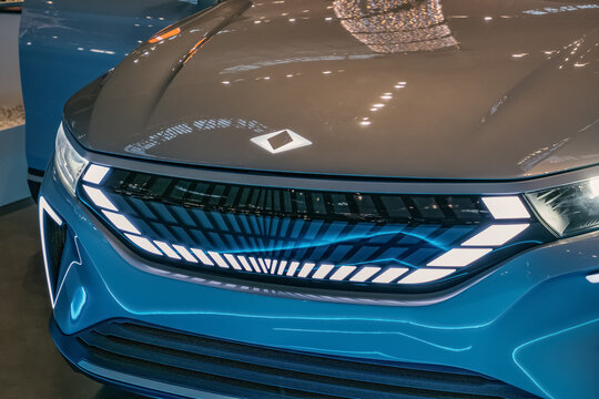 Close-up of glowing TOGG electric car logo on sleek hood at night. Istanbul, Turkiye - December 7, 2022.