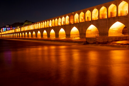 Zayandeh Rud River Flowing Under the Illuminated Si-o-Se Pol Bridge on a Peaceful Night in Isfahan