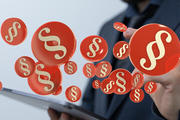 Abstract image of paragraph symbols hovering over a tablet, representing digital law or legal tech.