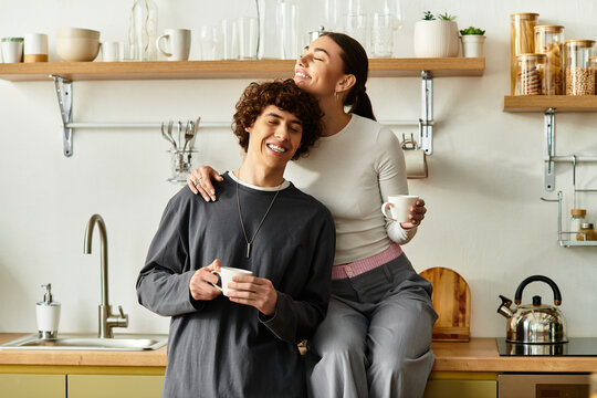 Joyful moments shared in a cozy kitchen while sipping warm drinks together - Powered by Adobe