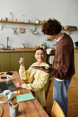 Loving couple enjoys a cozy home moment over coffee and playful conversation