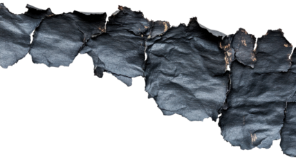 Torn pieces of black leather are layered together, creating an interesting texture and pattern with sharp edges