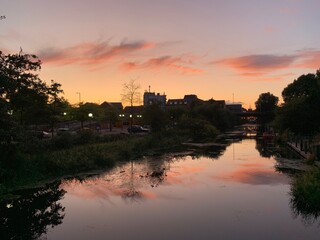 Fototapeta premium sunset over the river with silhouette and reflections. 