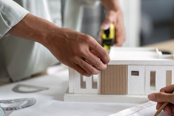 Architect Measuring Model Dimensions for Sustainable Building