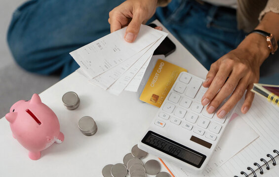 Financial Planning. Individual calculating expenses with receipts and a calculator.