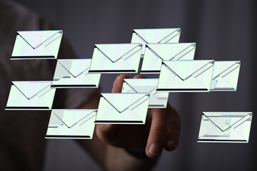 Hand interacting with digital emails,concept of email overload, inbox management.