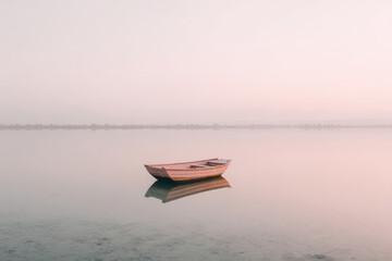minimalist scene of solitary vessel on turkish lava field at sunrise