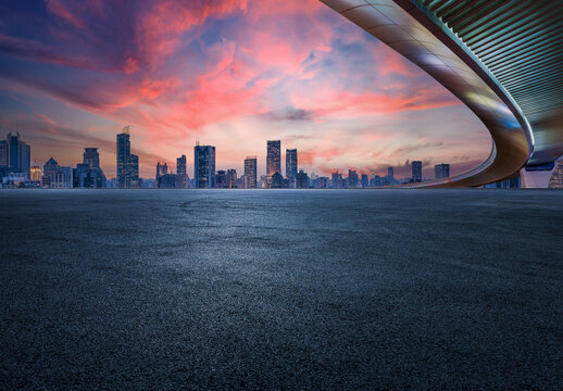 Asphalt road and bridge with city skyline in Shanghai at sky sunset, China. 
