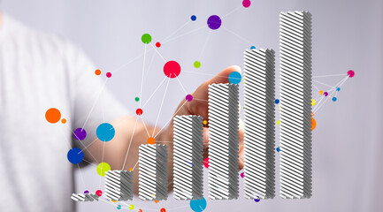 Stock photo of a hand interacting with a 3D bar graph showing growth.  Ideal for business, finance,...