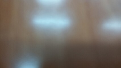 Abstract Brown Surface with Soft Light Reflections - Blurred Background Texture