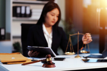Judge gavel with Justice lawyers having team meeting at law firm background. Concepts of Law and...