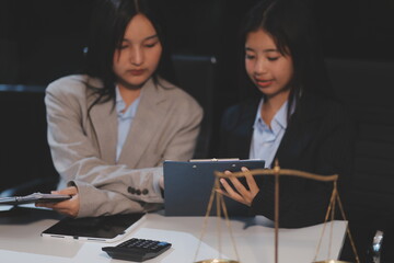 Judge gavel with Justice lawyers having team meeting at law firm background. Concepts of Law and Legal services.