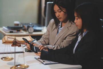 Judge gavel with Justice lawyers having team meeting at law firm background. Concepts of Law and...
