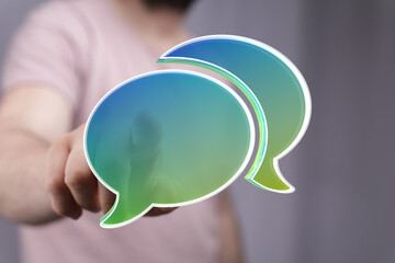 Abstract image of a person interacting with digital speech bubbles, representing communication and...
