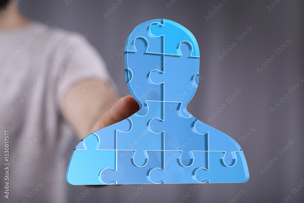 Poster abstract image of a person formed by puzzle pieces, symbolizing teamwork, collaboration, and unity.