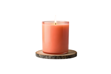 Orange candle in clear glass container on wooden tree slice coaster, flame burning bright, isolated on a transparent background